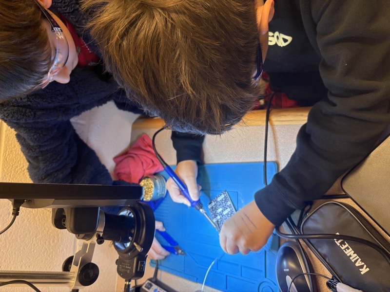 Students learning soldering at the electronics station in the i.Lab pilot